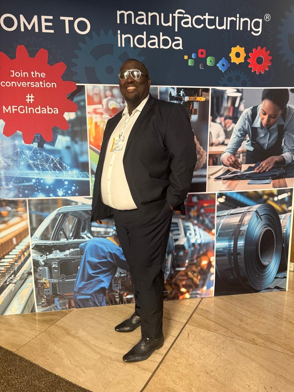 Representative standing at a manufacturing industry event display