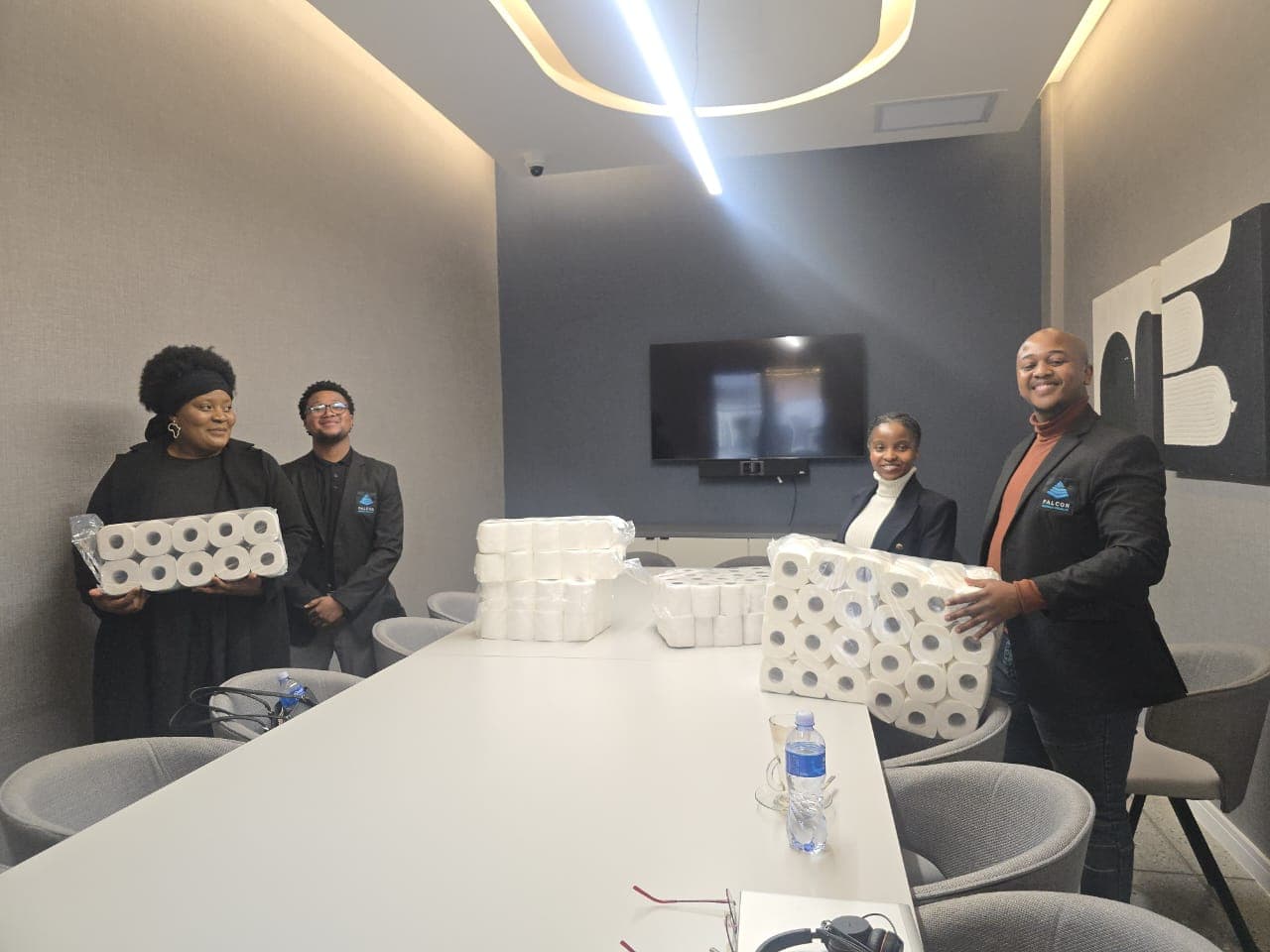 Team members with packaged supplies in a meeting room