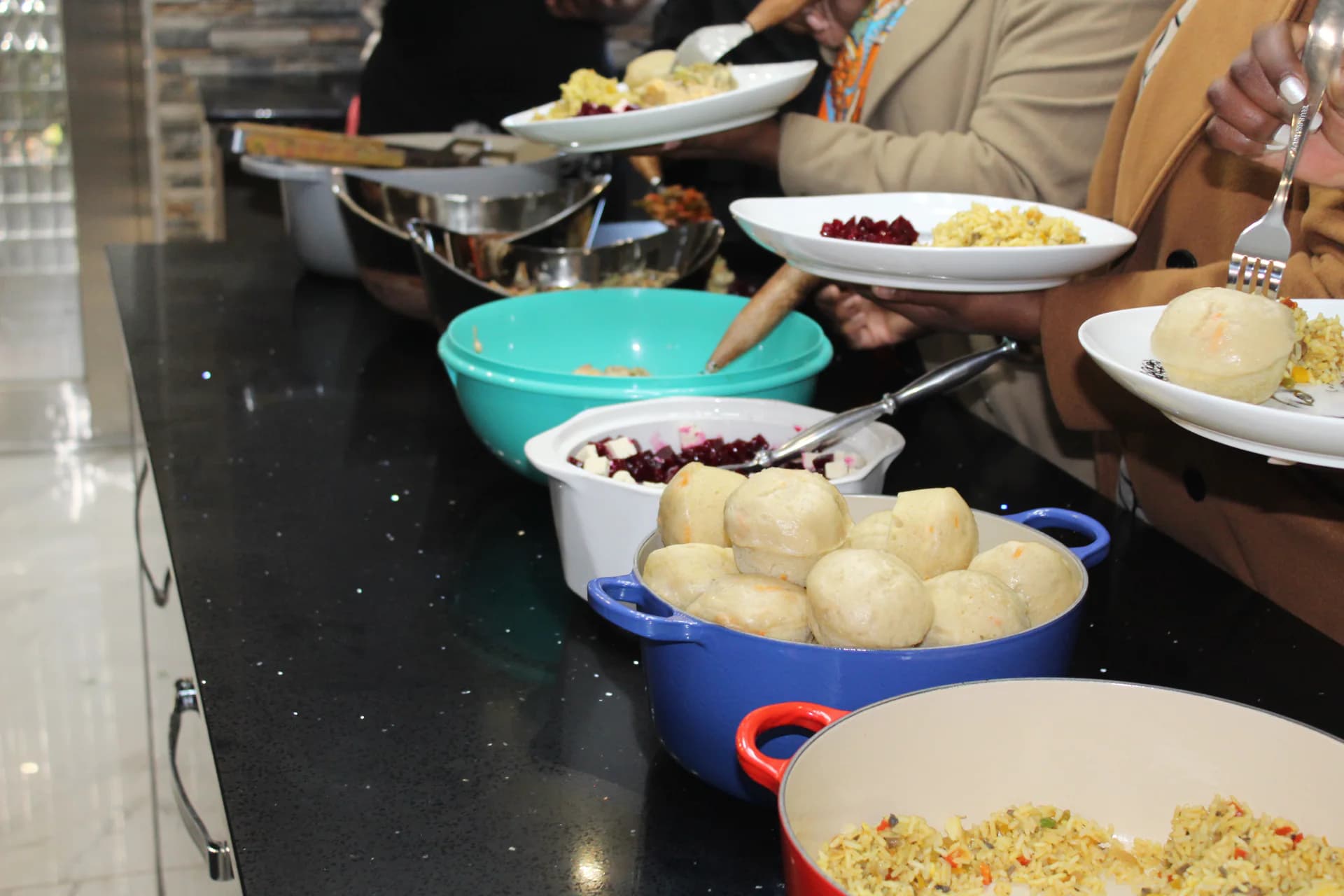 Prepared dishes and plates arranged on a Falcon Kitchen service counter