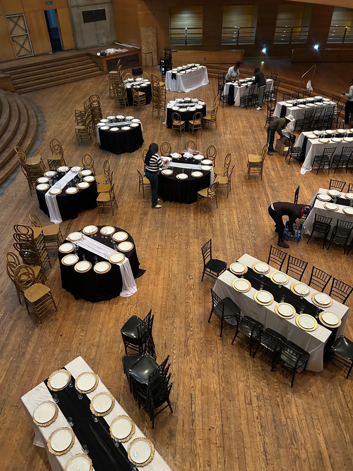 Overhead view of an event venue while staff prepare dining tables