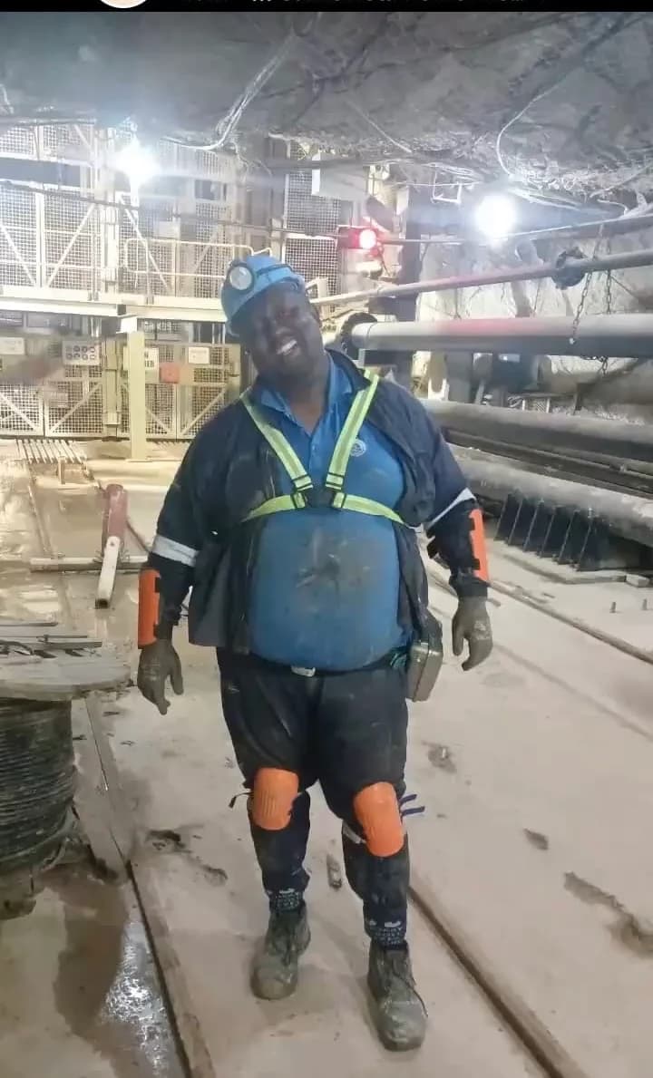Mine worker wearing underground protective equipment inside a real mining operation