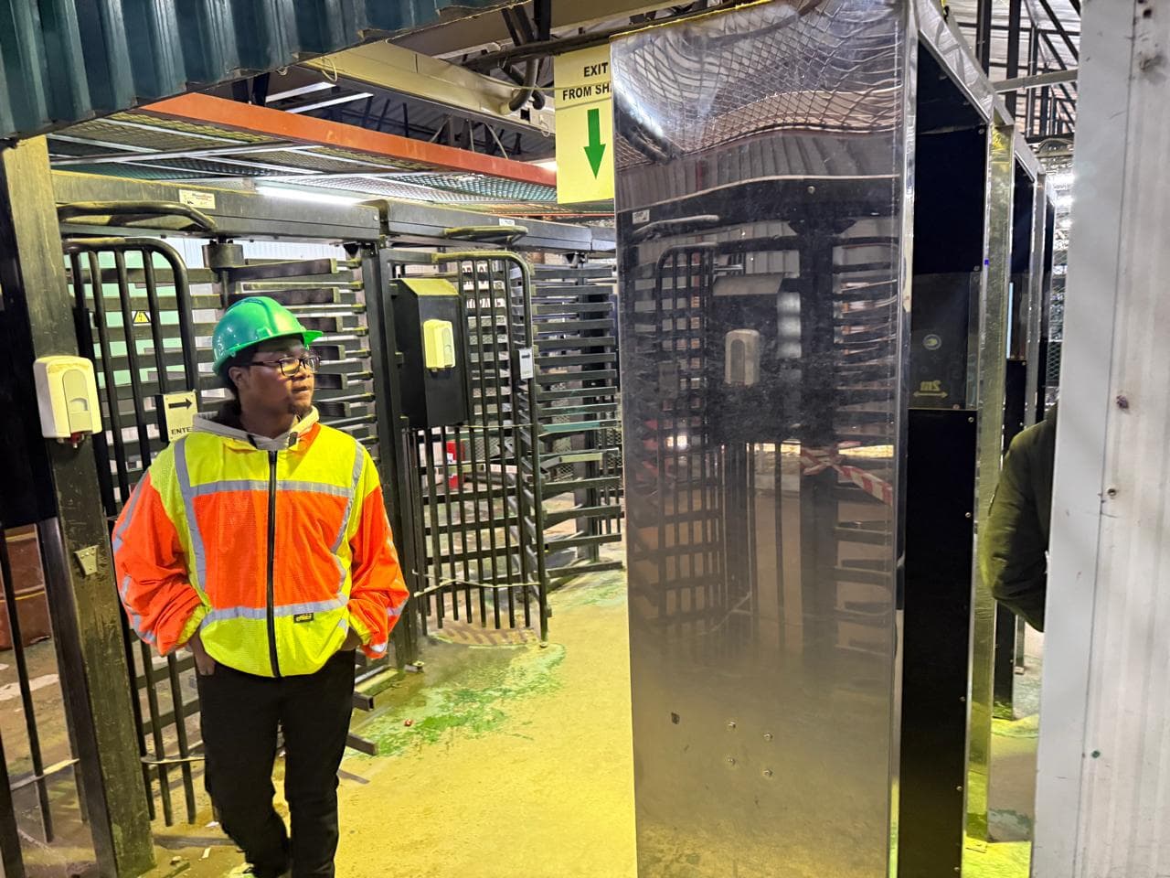 Worker standing near a turnstile installation area