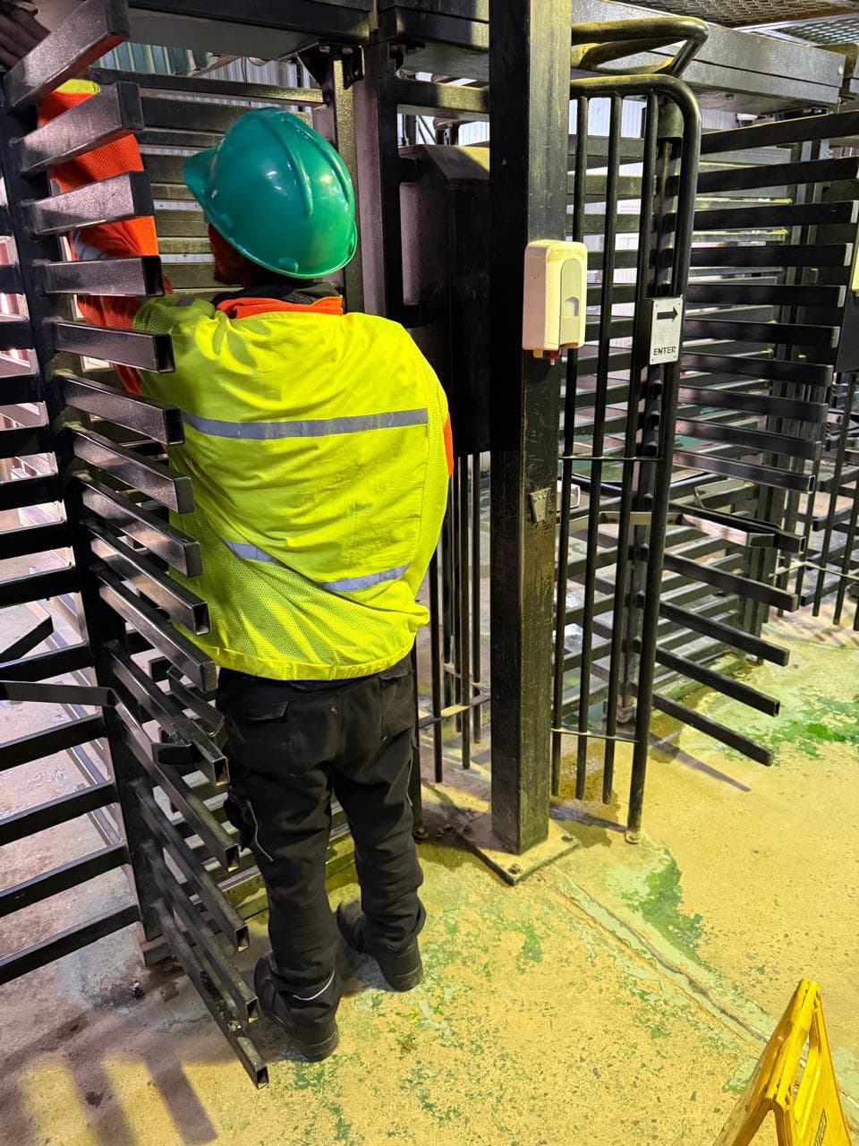 Technician inspecting access turnstile equipment