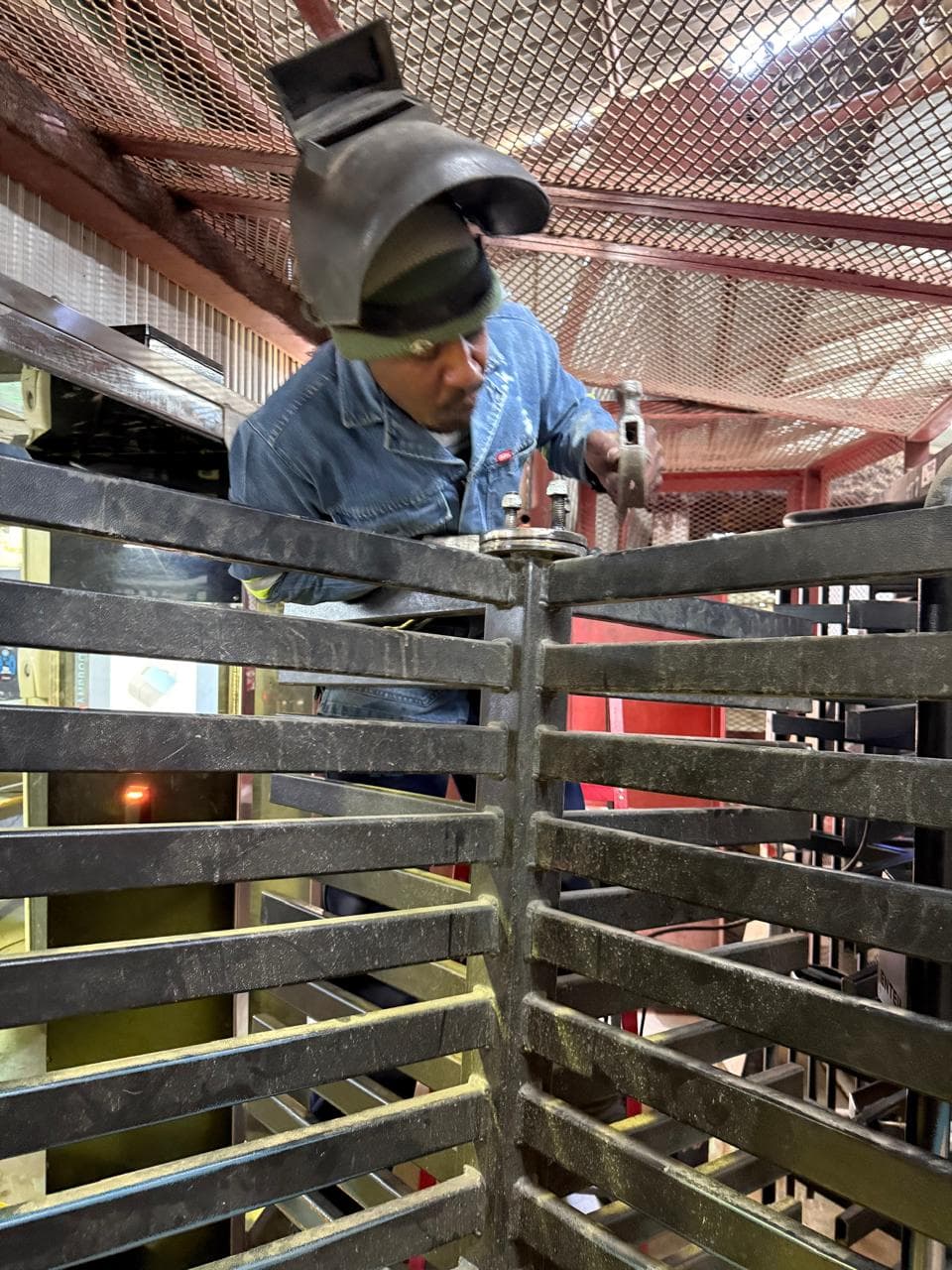 Worker adjusting components on a turnstile installation