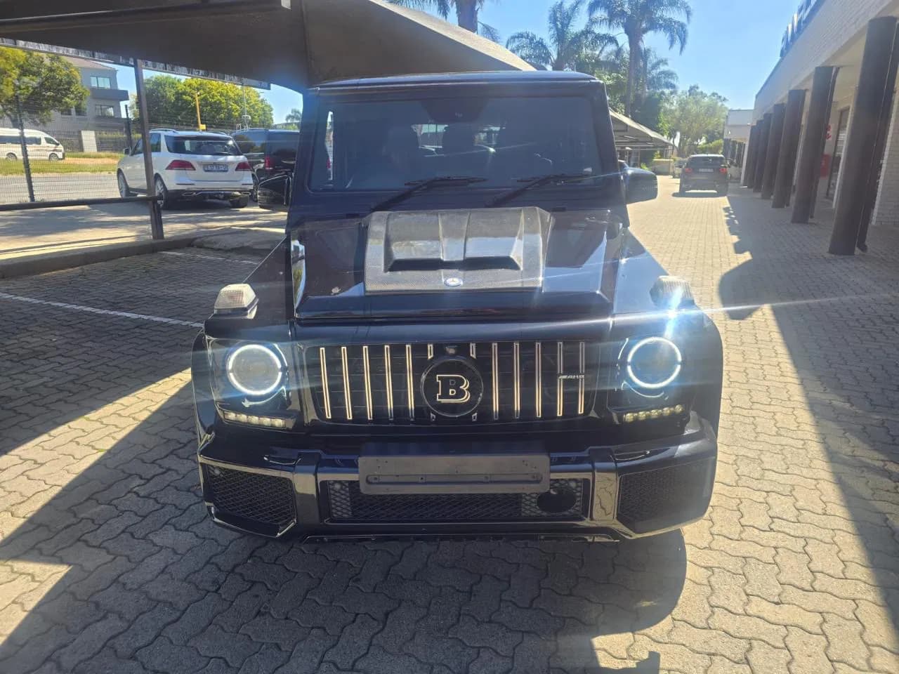 Black tour vehicle photographed from the front
