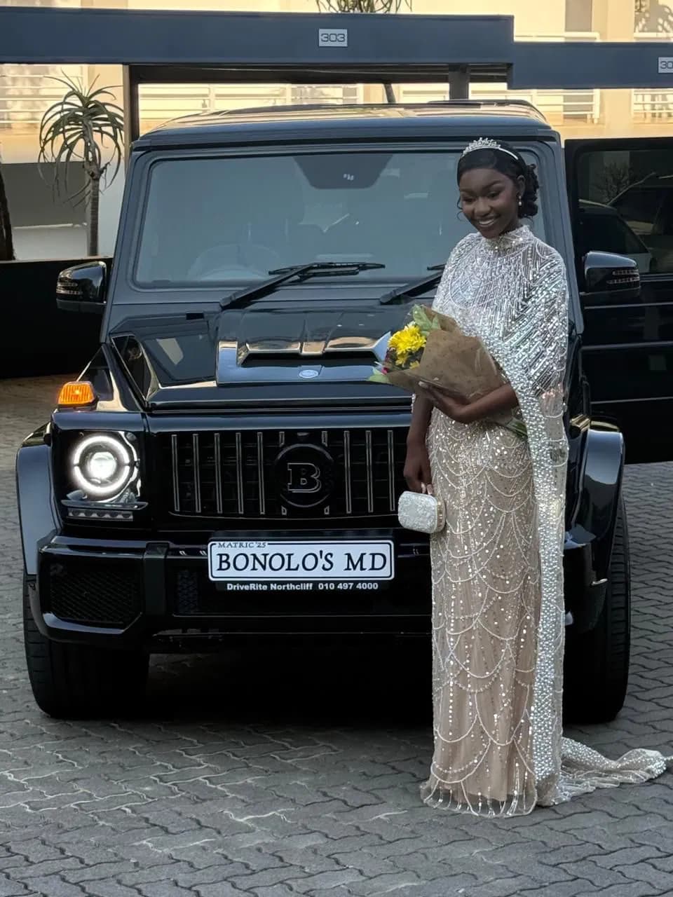 Guest standing beside a black tour vehicle