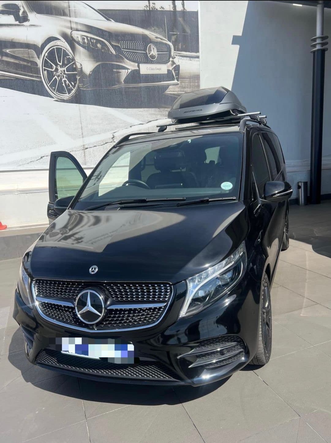 Black Mercedes shuttle vehicle at a service location