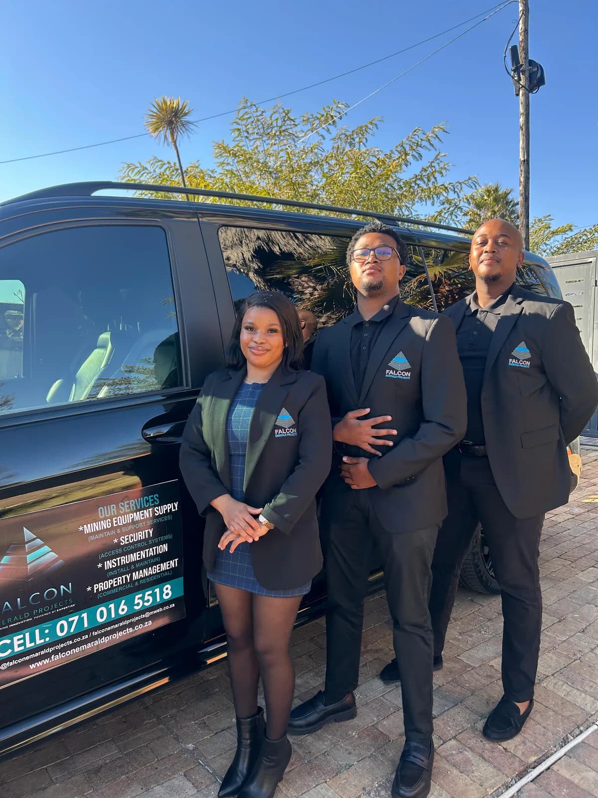 Transport team photographed beside a branded shuttle vehicle