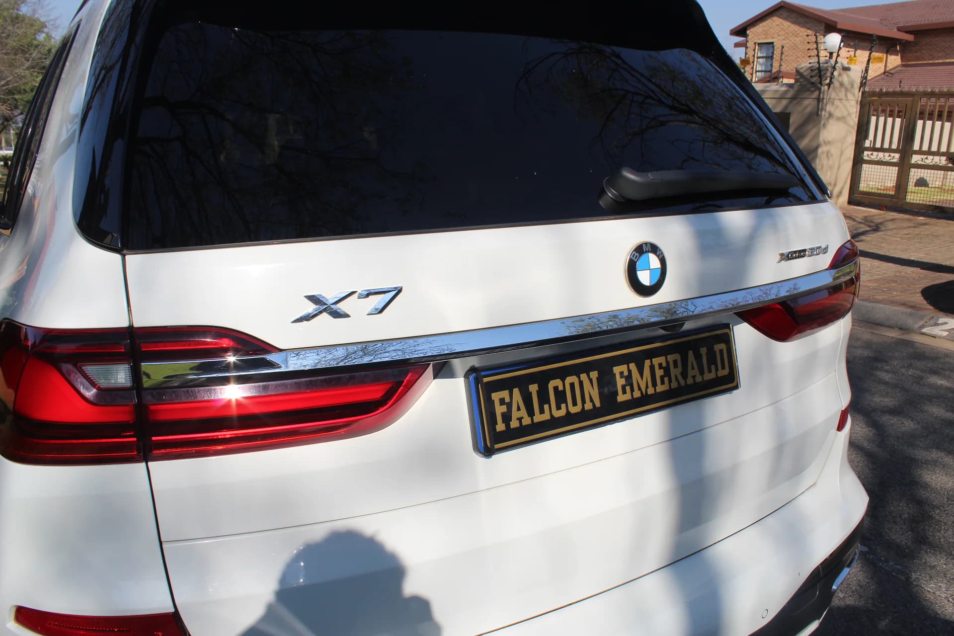 BMW X7 rear branding detail with Falcon Emerald plate